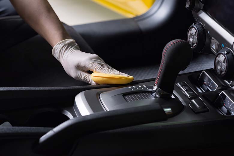 person cleaning interior of a car